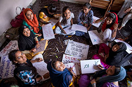 Photo of people making signs. Link to What to Give Photo of people making signs. Link to What to Give